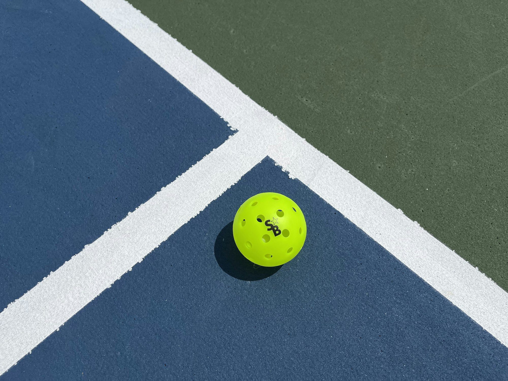 Pickleball on a blue and green court